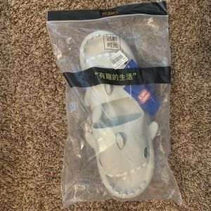 BRAND NEW LIGHT GREY SHARK SLIDES .